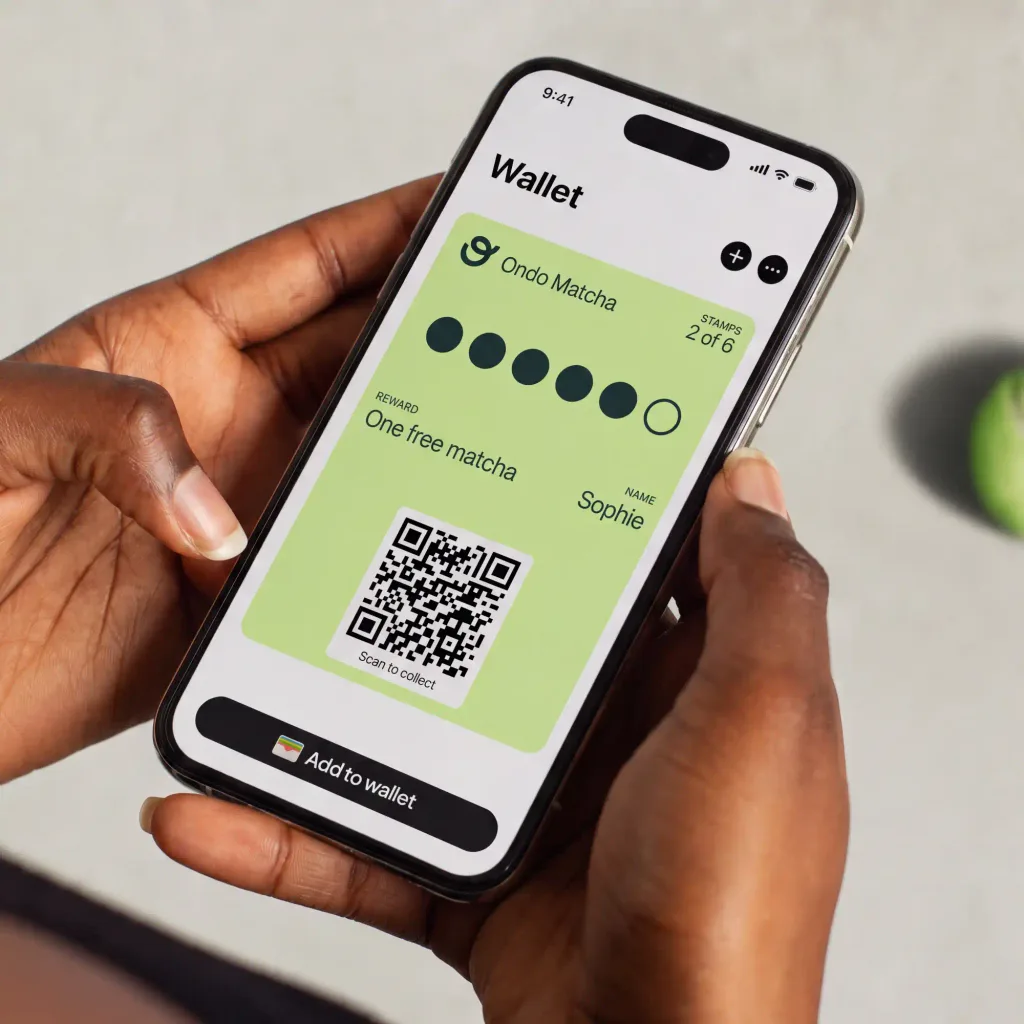 Ondo Matcha stamp card in Apple Wallet, 2 of 6 stamps, held in a customer's hands